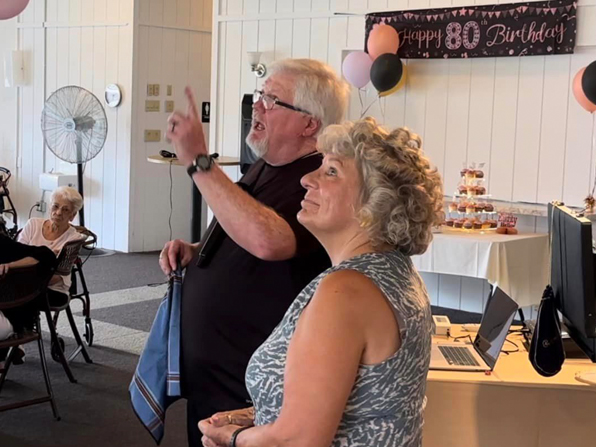 Chuck performs with a spectator at an 80th birthday party. Chuck performs with a spectator at an 80th birthday party.