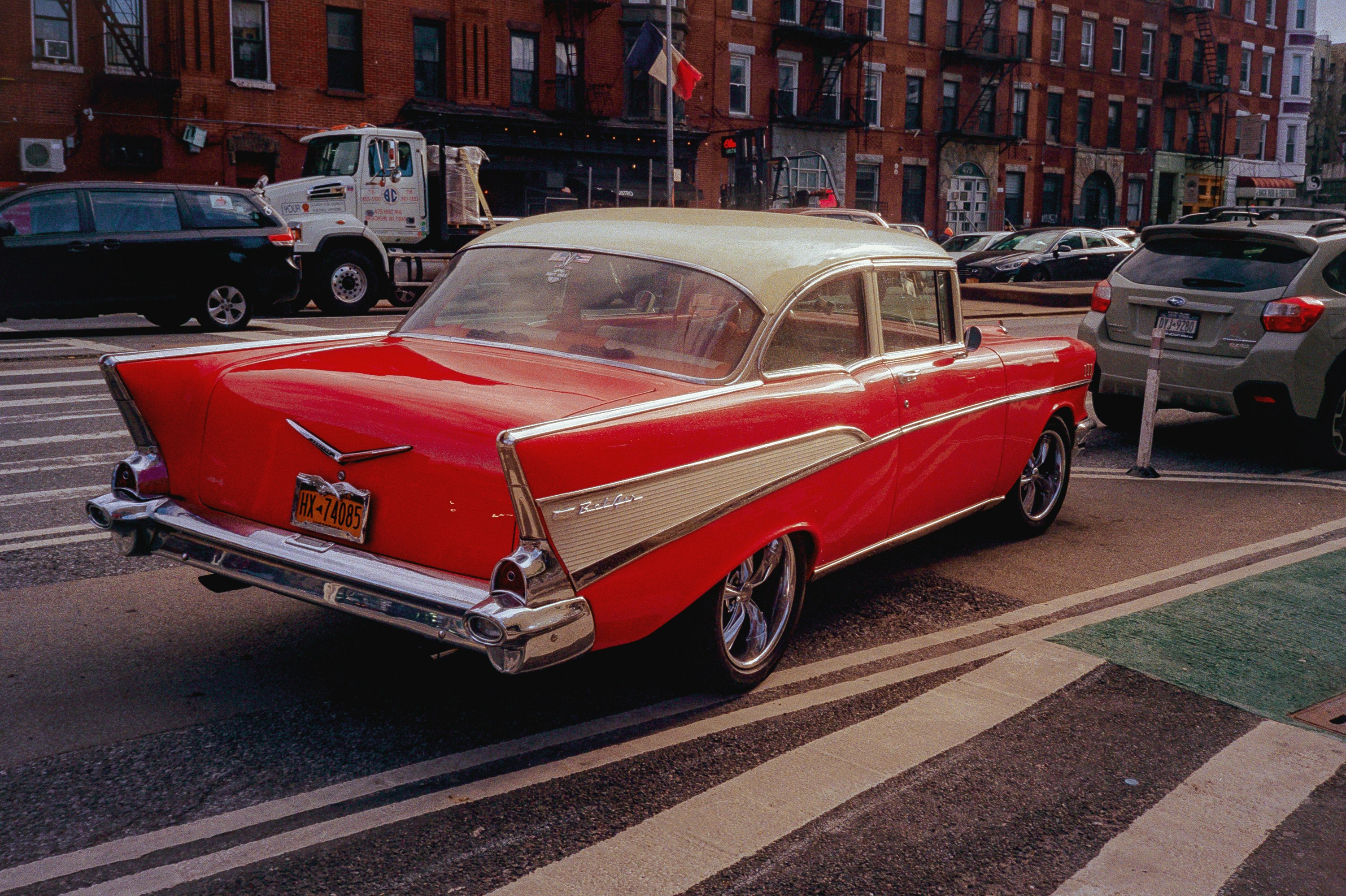 red and white vintage car on road during daytime
