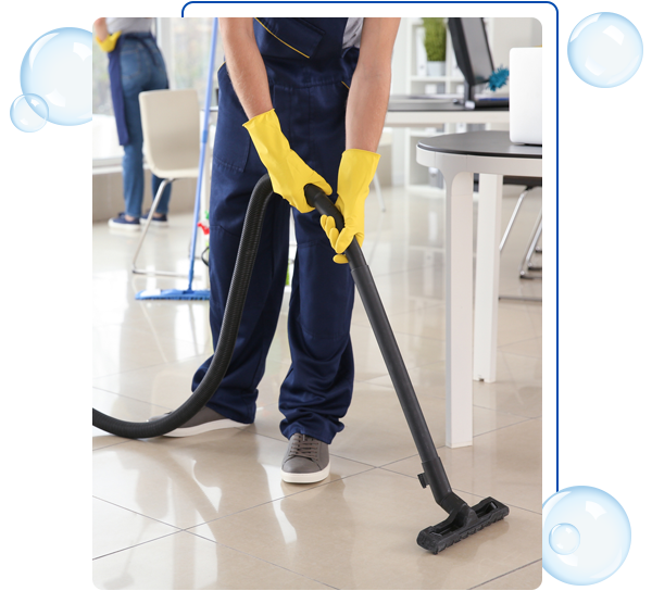 Janitor hoovering floor in office