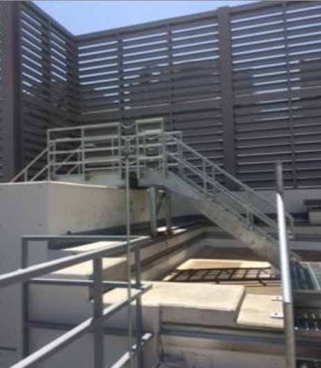 Steel stairway over a concrete area.