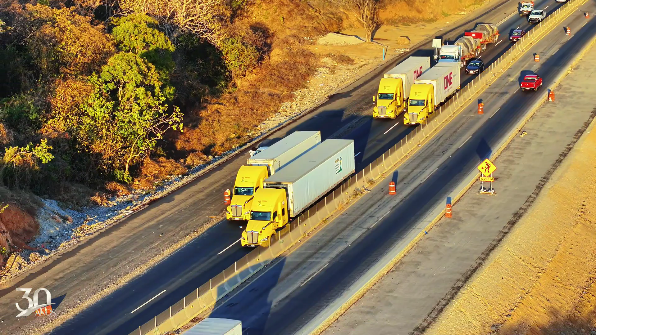 Camión blanco grande en movimiento dentro de un túnel bien iluminado.