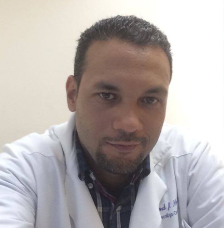 Smiling man in a white coat