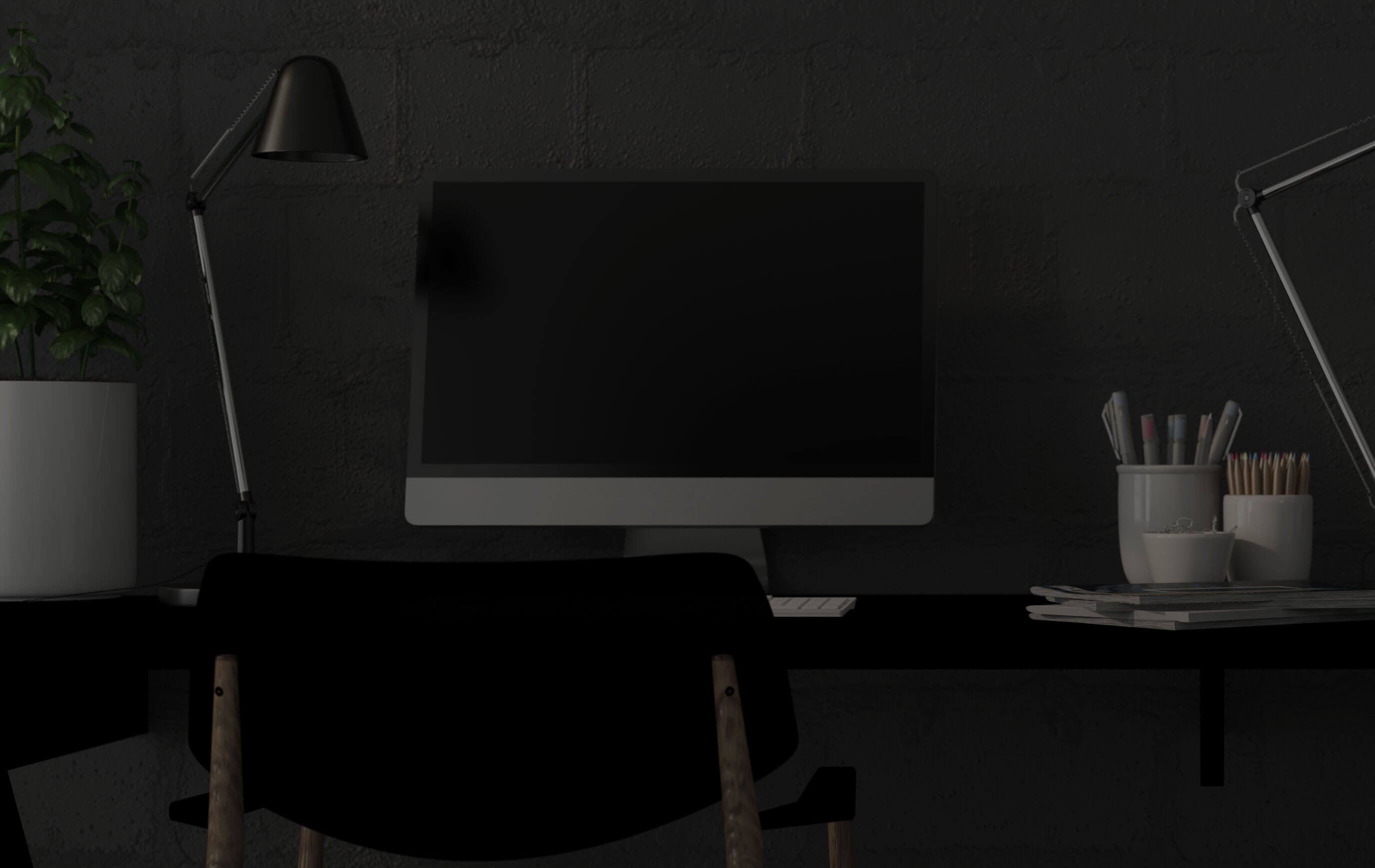 Oficina moderna con computadora de escritorio, lámpara de escritorio negra y planta en maceta.