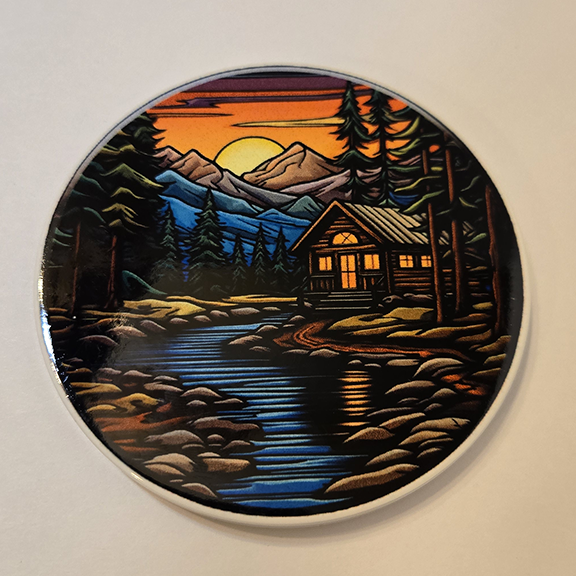 Round ceramic coaster with a stained glass cabin design