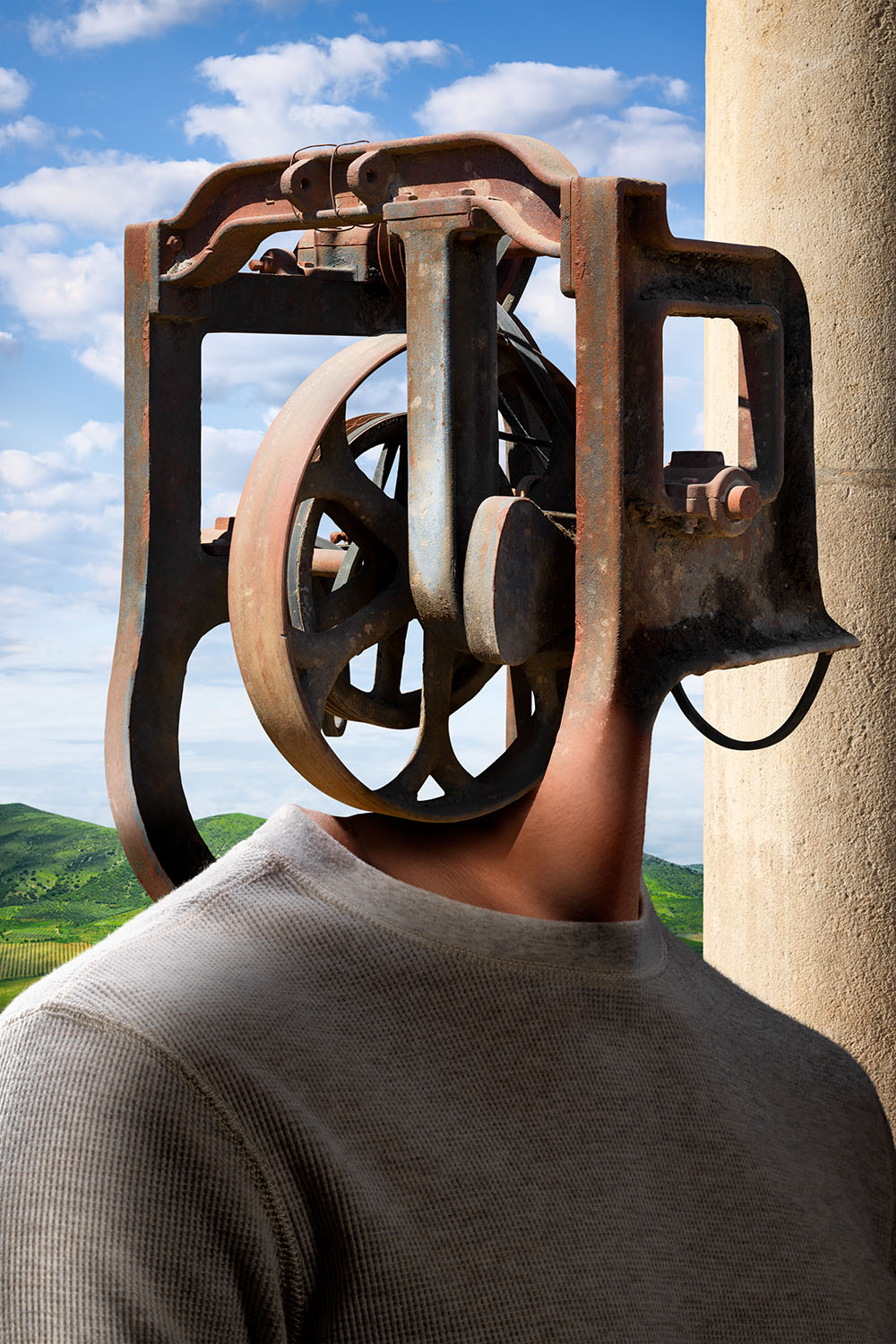 Surrealistic portrait of man with rusted industrial machinery for his head.