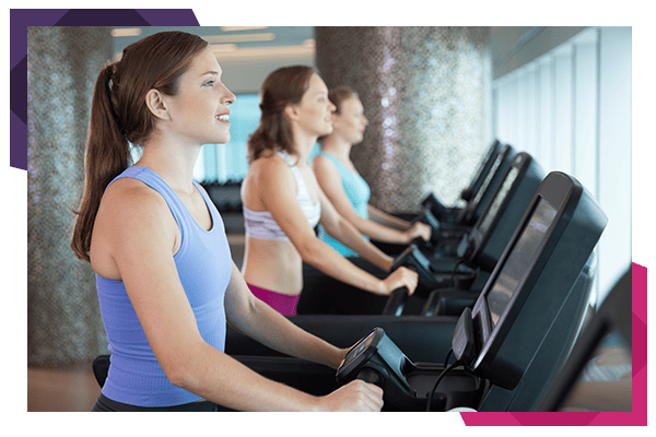 Young Women Running on Treadmills in Fitness Club