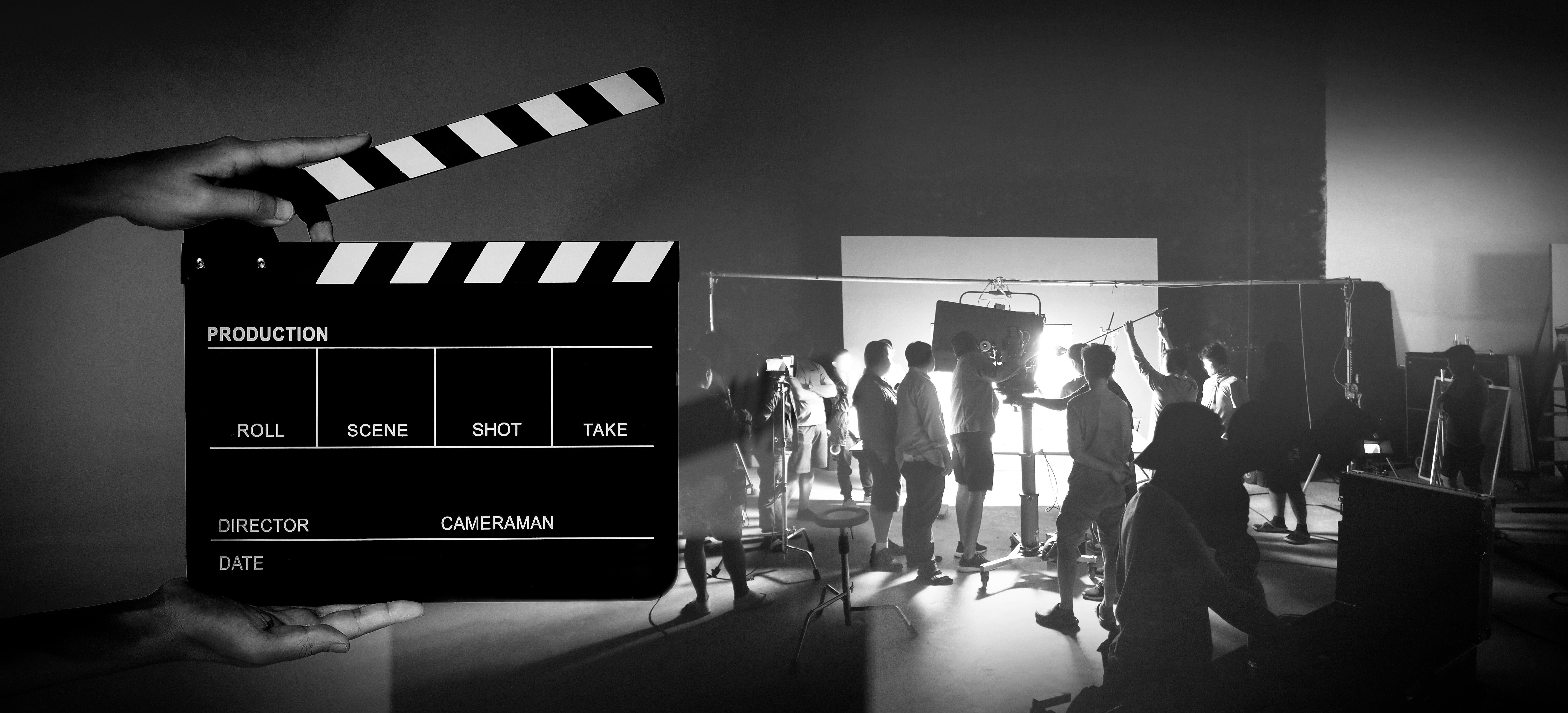 https://0201.nccdn.net/1_2/000/000/187/b02/hand_and_film_slate_in_front_of_camera_and_video_production_stud.jpg