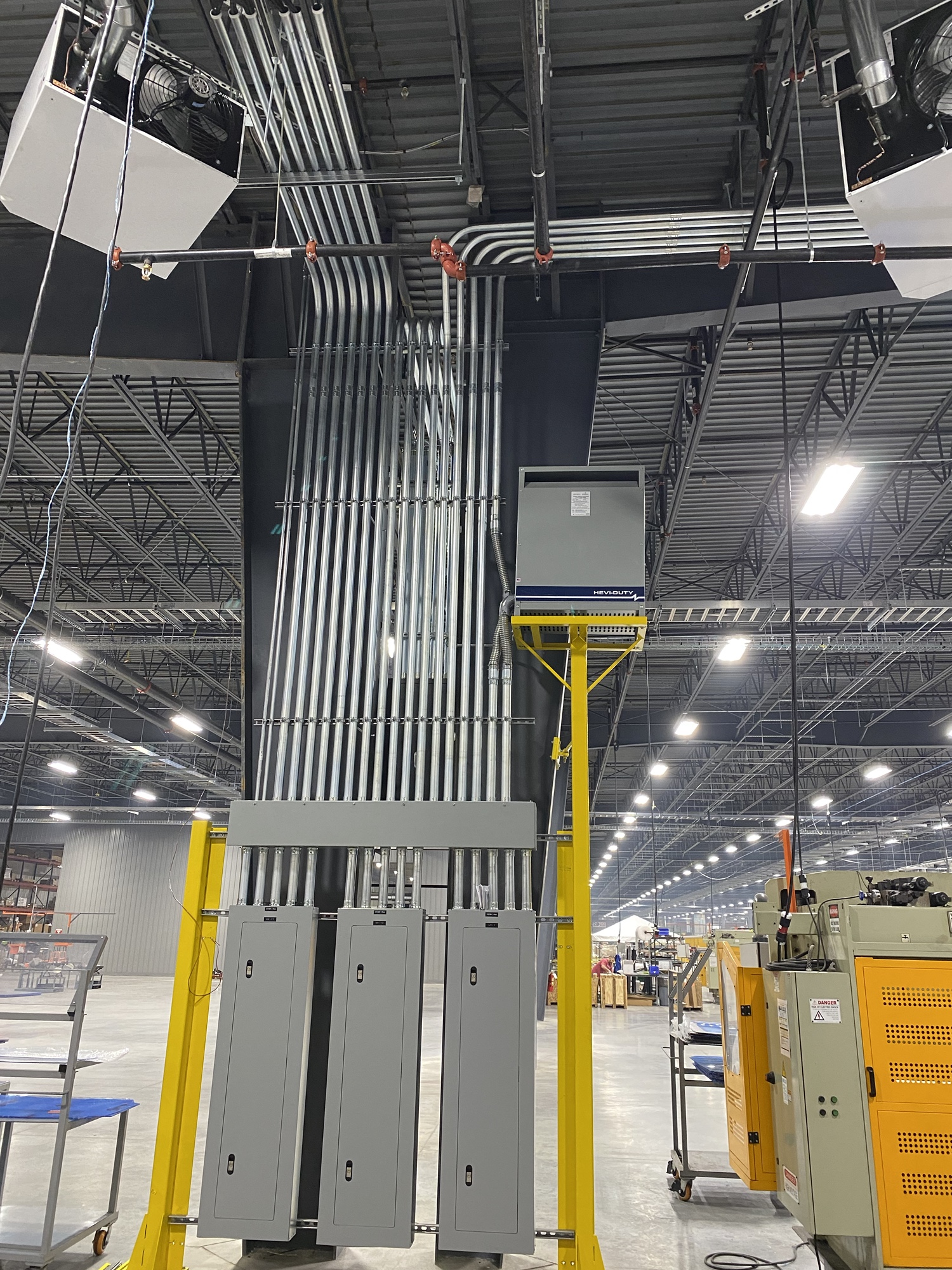 Well-lit parking lot at night with covered parking spaces and disabled parking spot.