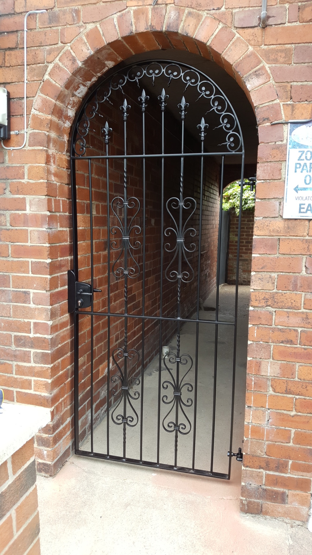 Traditional decorative gate fabricated for extra security to side of property.