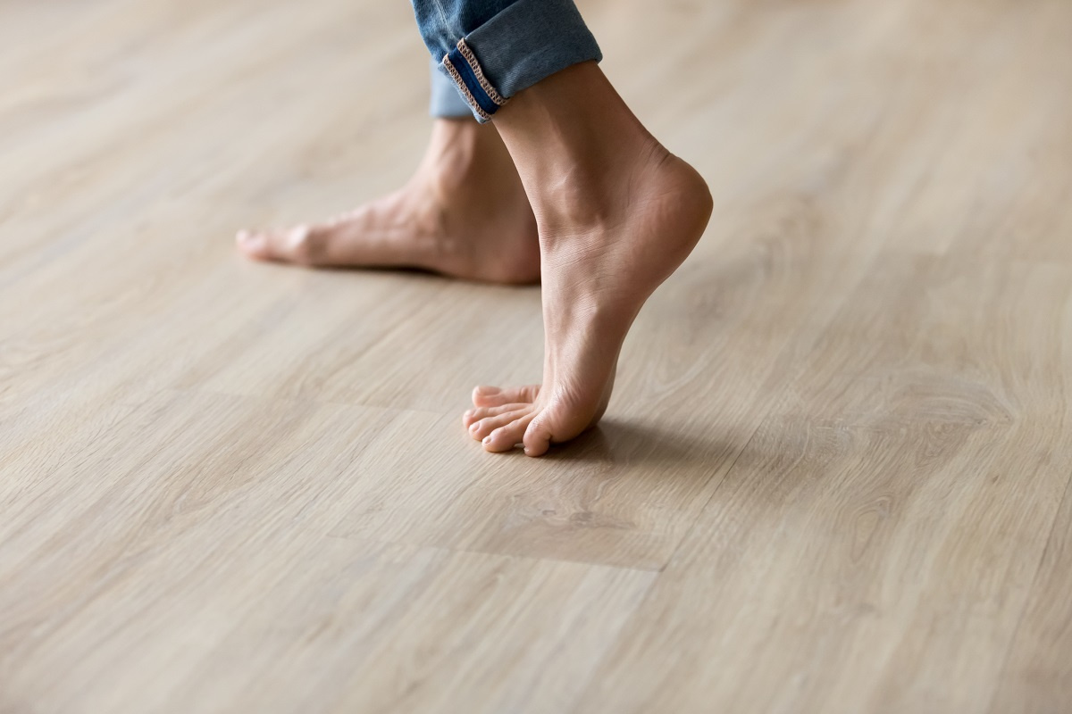 Woman standing on hardwood floor Woman standing on hardwood floor