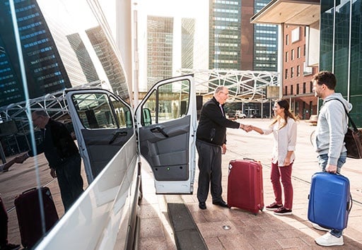 Airport Shuttle Driver and Passengers in a Big City