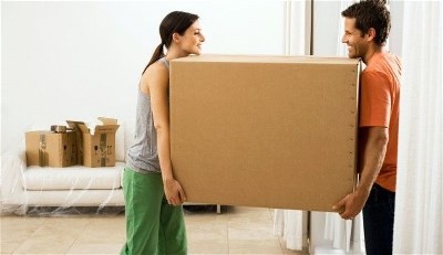 man and woman carrying large box man and woman carrying large box