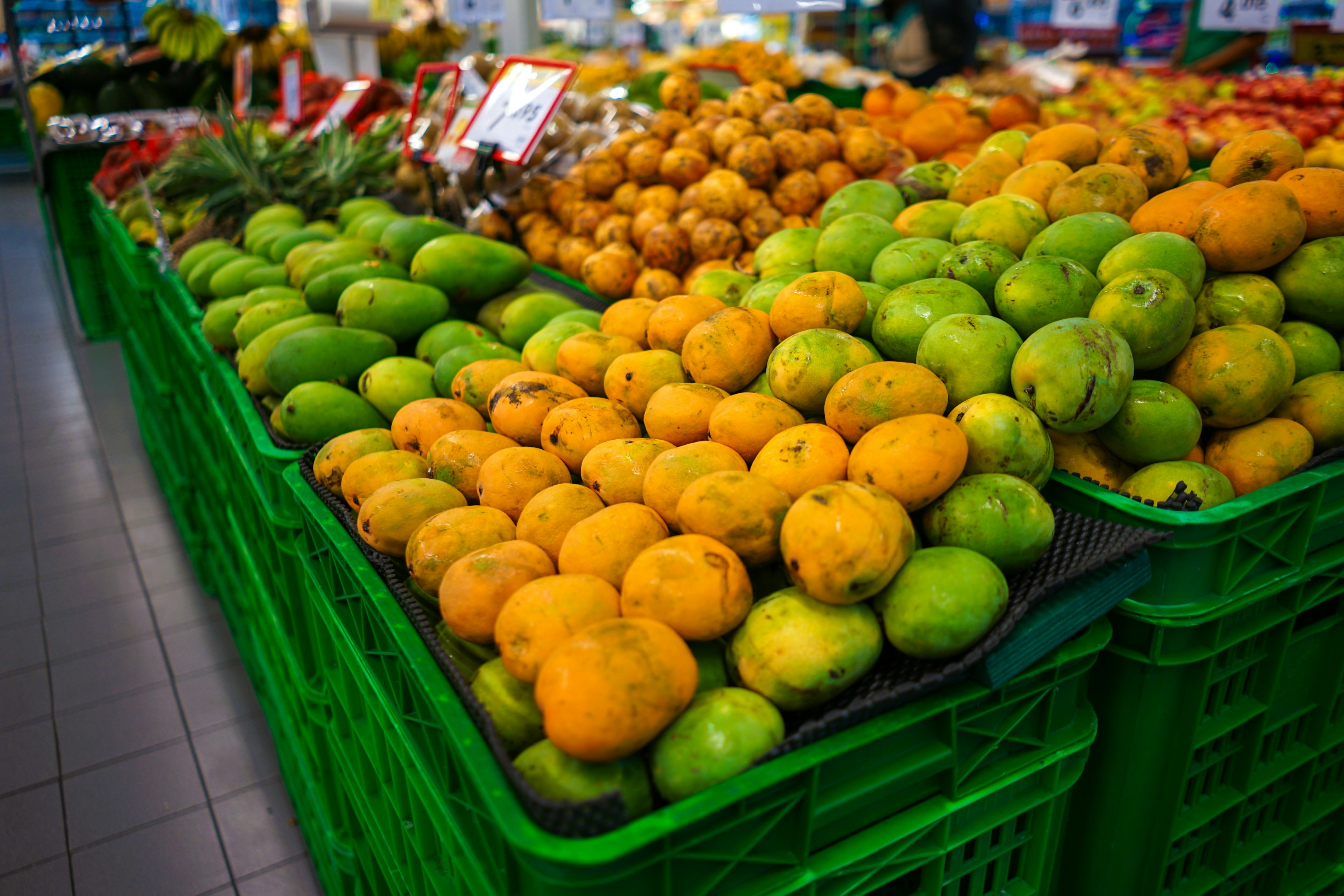 a man standing in front of a fruit stand