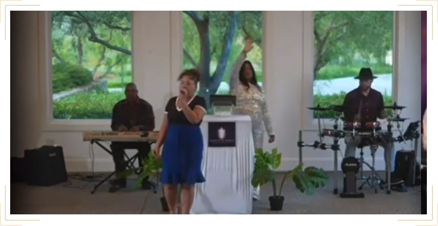 People on stage worshipping and singing to music