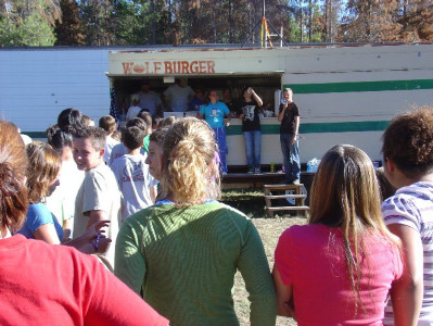 Kids waiting in line for evening meal to be served out of the "WolfBurger".