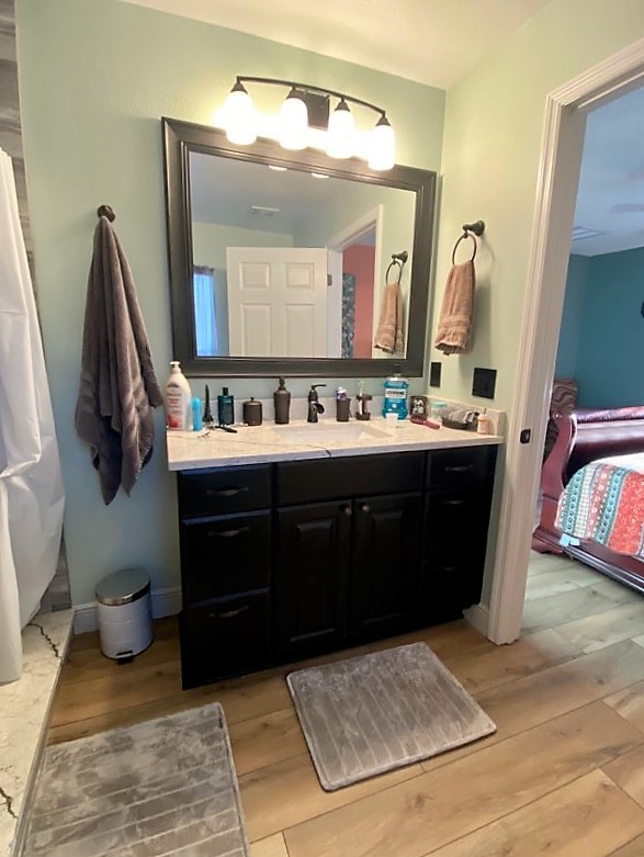 Stylish bathroom vanity with single sink & quartz countertop.