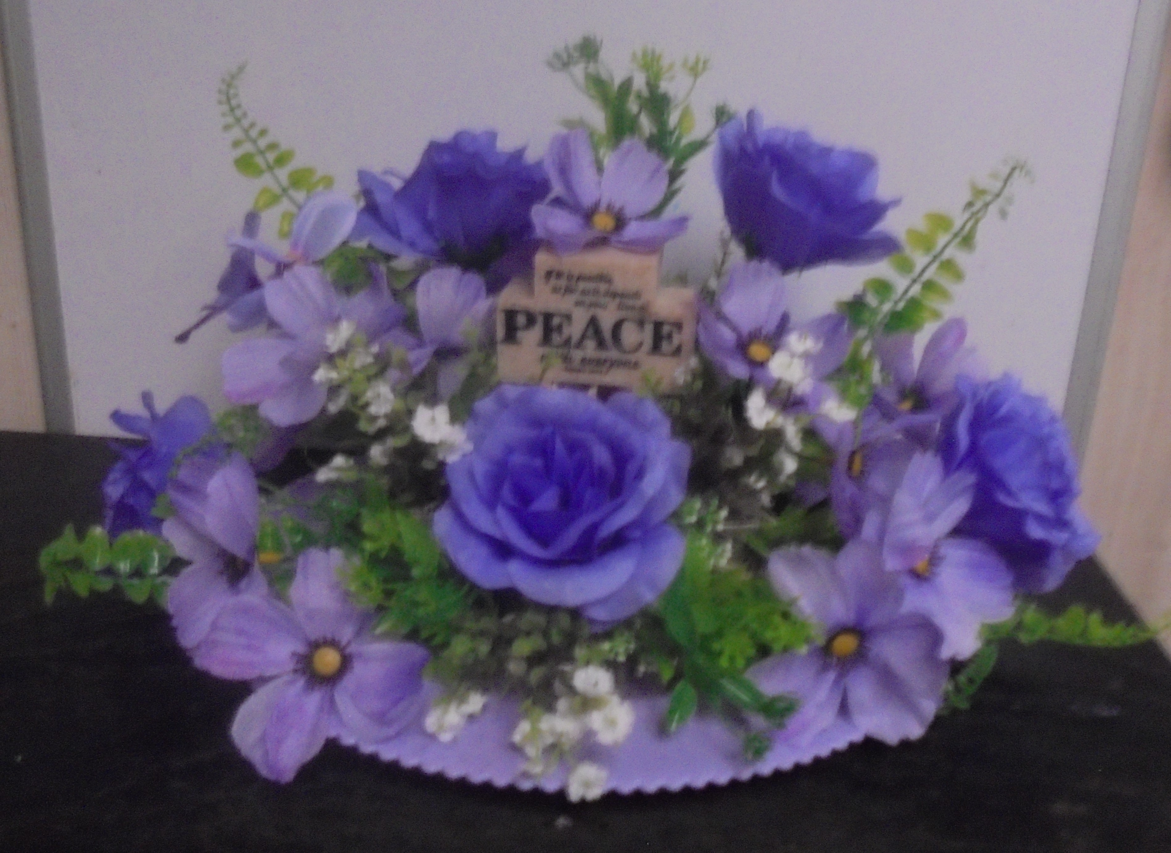 (32) "Silk" Arrangement
With Peace Cross (Lavender)
$45.00