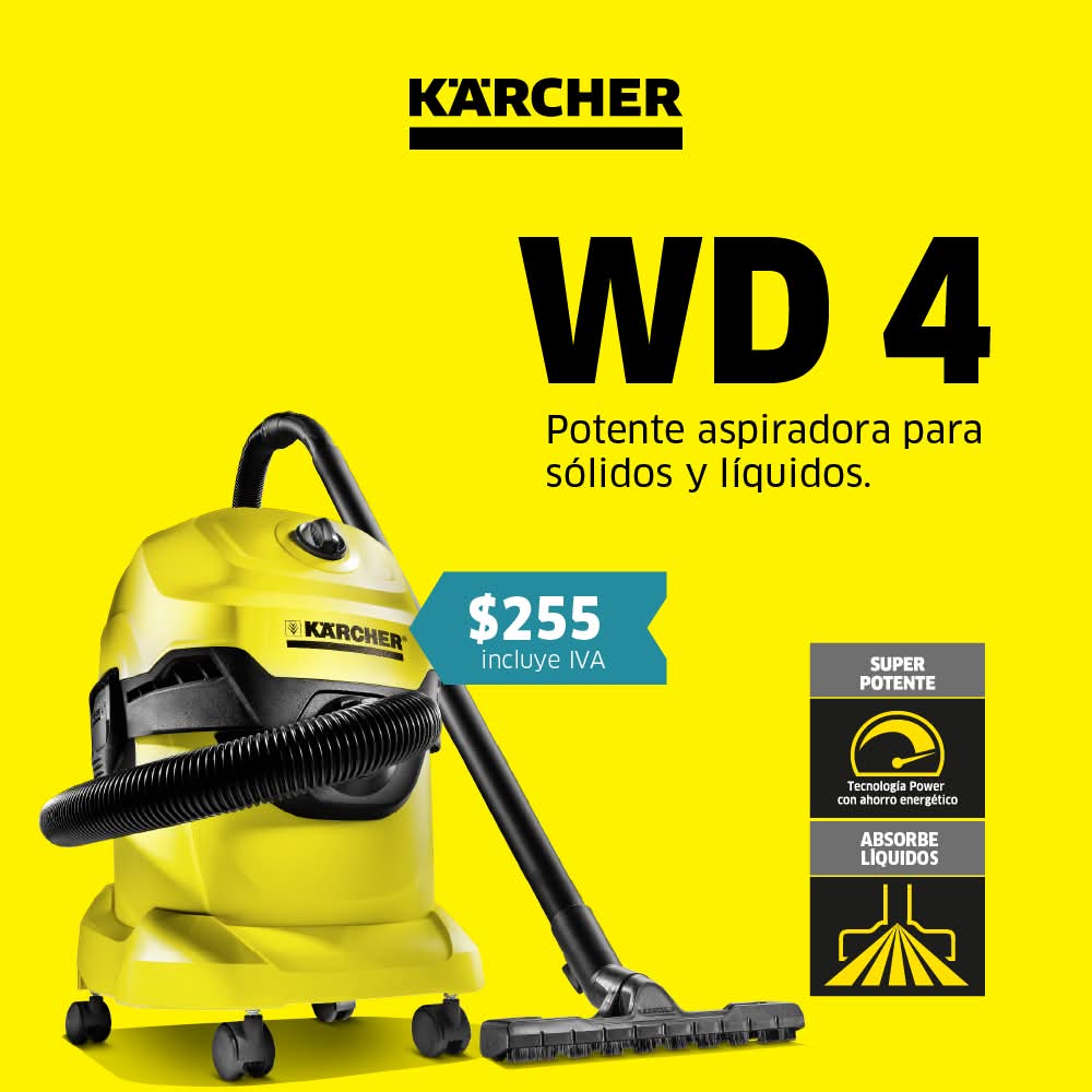 Tres trabajadores de limpieza conversando y usando una aspiradora industrial azul en un amplio espacio moderno con luz natural.