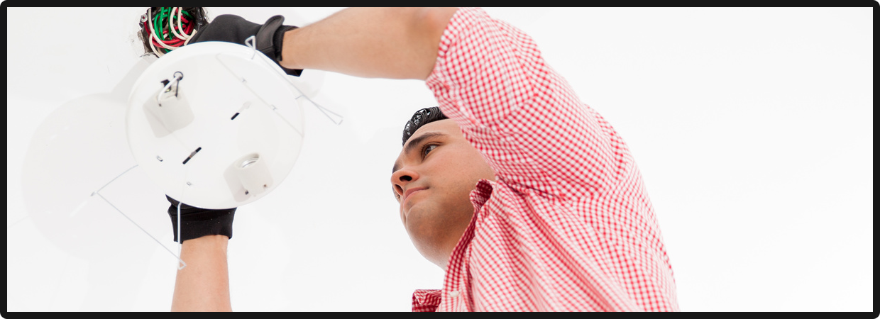 Electrician installing a lamp
