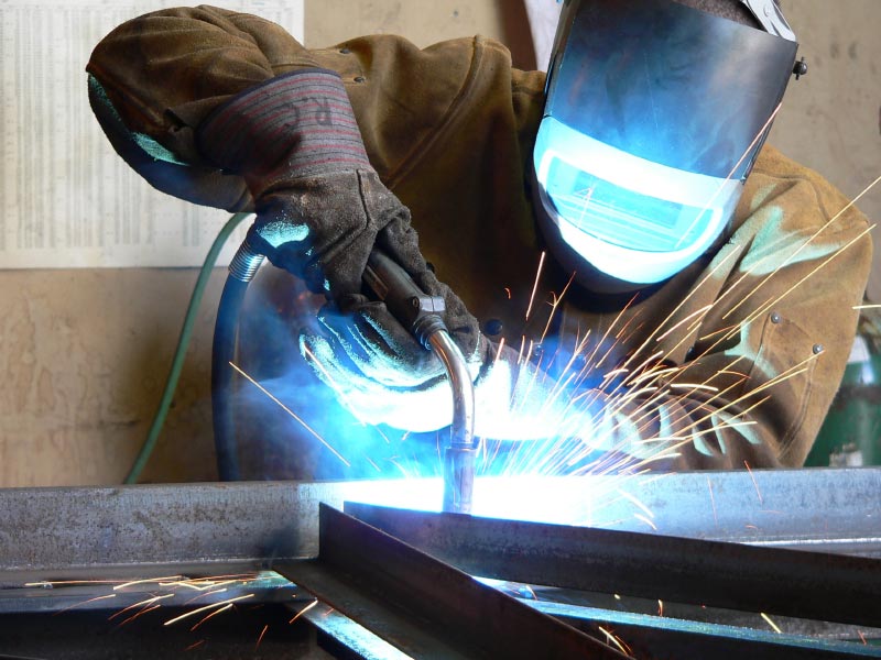A welder welding a steel beam