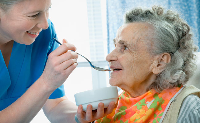Senior Woman 90 Years Old Being Fed by A Nurse