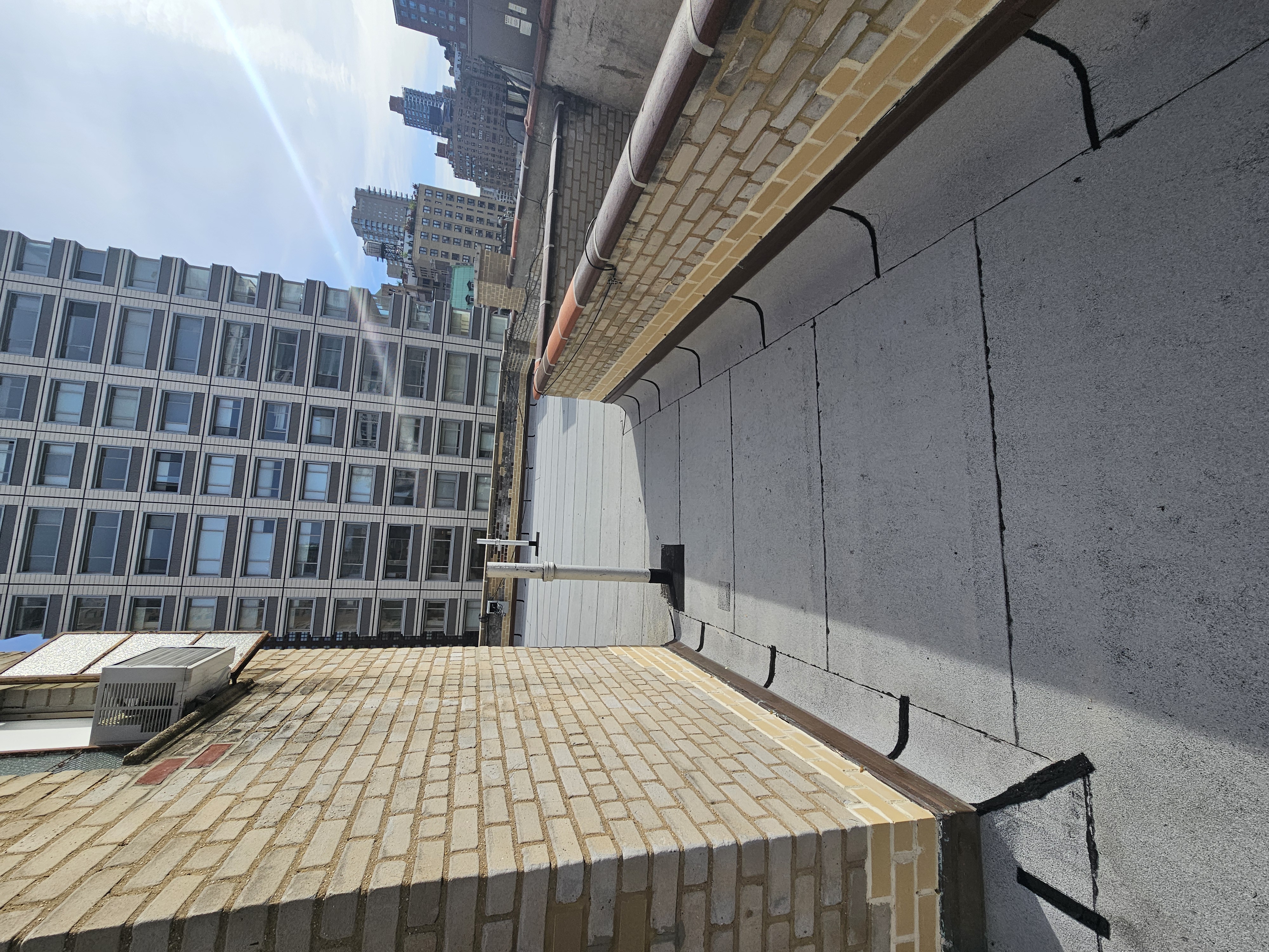 On the top off a roof of a brick building