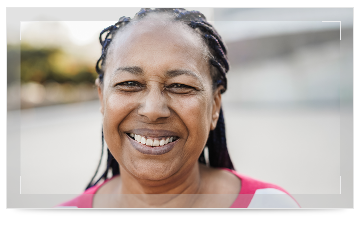 A senior African American woman happy and outside