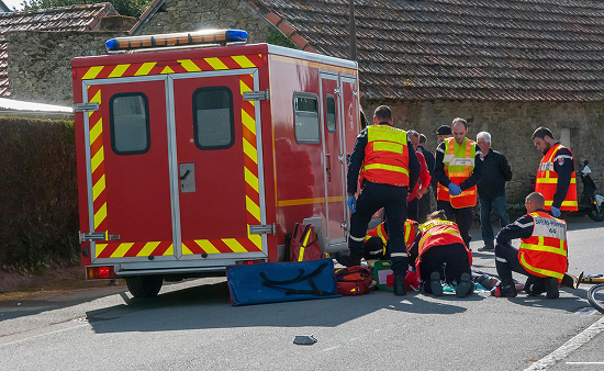 Firefighters treating an injured person on the ground Firefighters treating an injured person on the ground