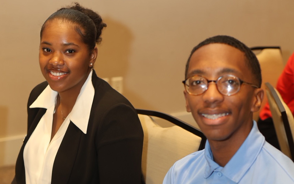Two students seated at an event