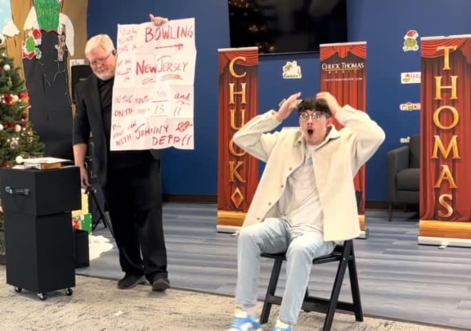 A spectator is amazed at his company's holiday party. A spectator is amazed at his company's holiday party.