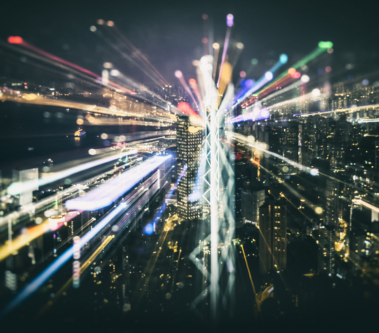 Technician holding a circuit board in front of a laptop