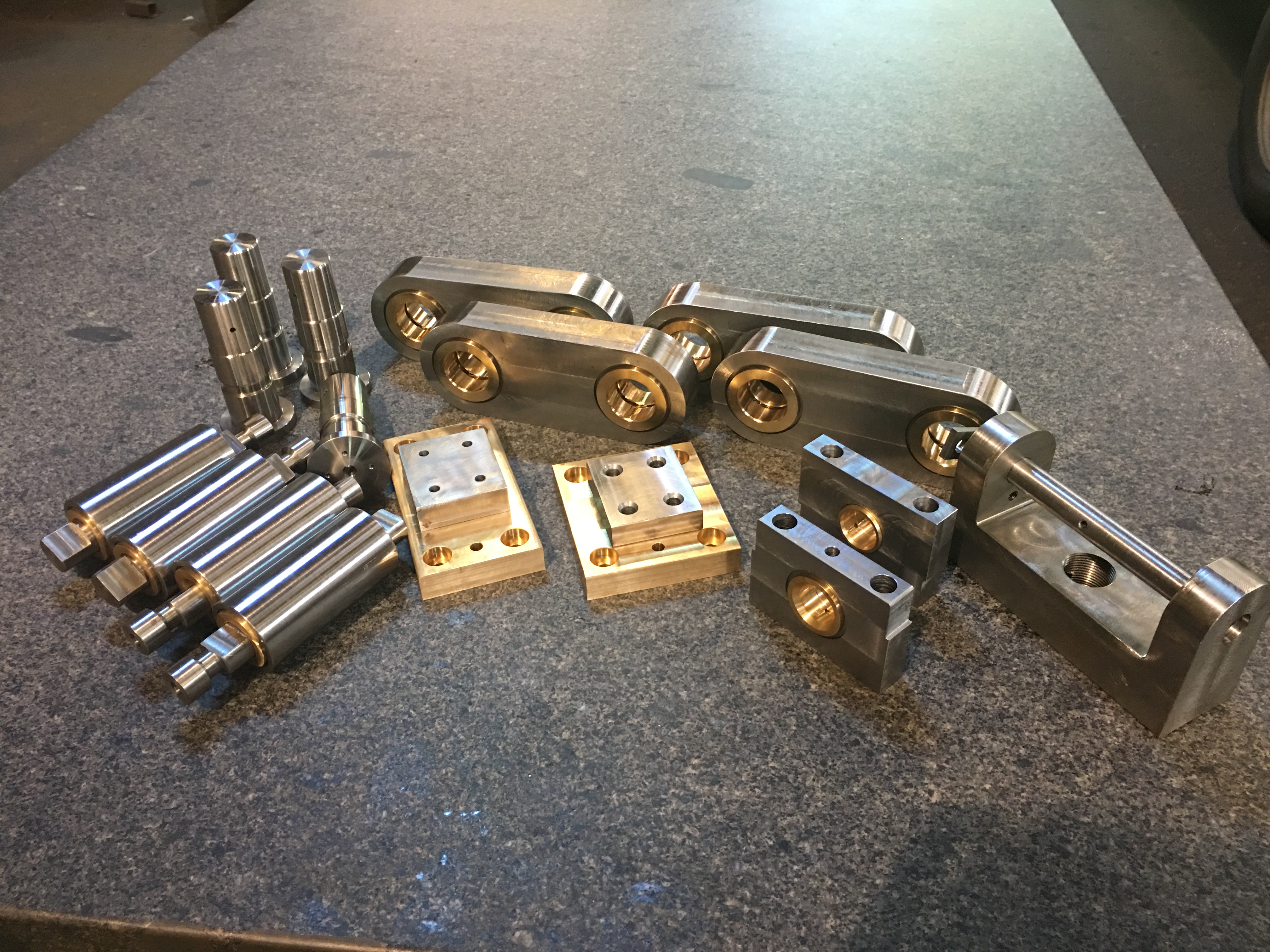 Modern CNC machine in a spacious industrial workshop with bright lighting and large windows.