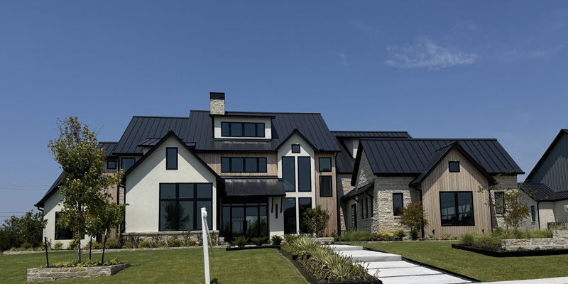 A large home with a black roof