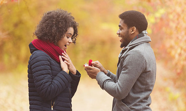 Romantic African American Man Proposing To African American Woman