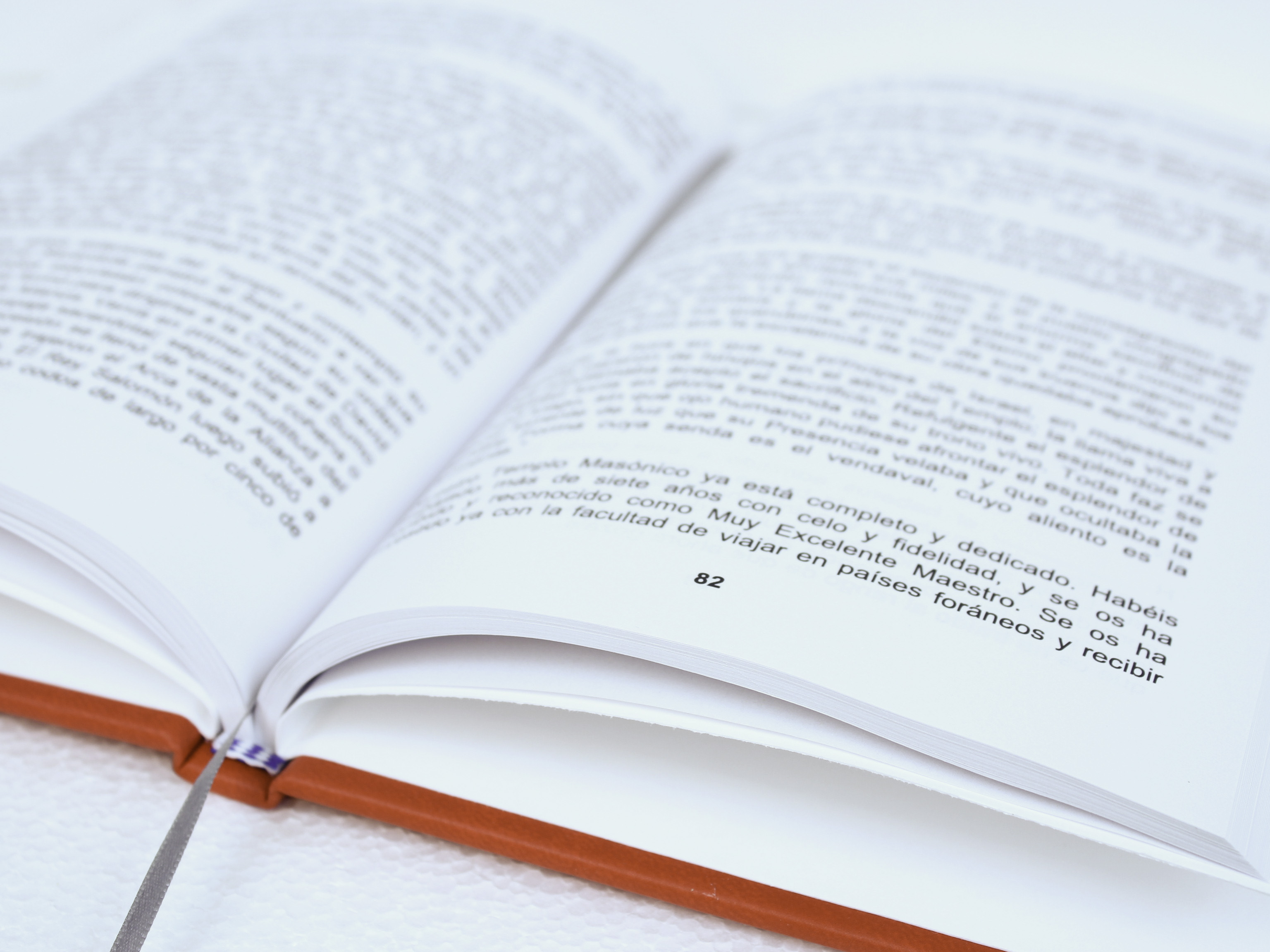 Happy child with glasses holding books and an apple on top