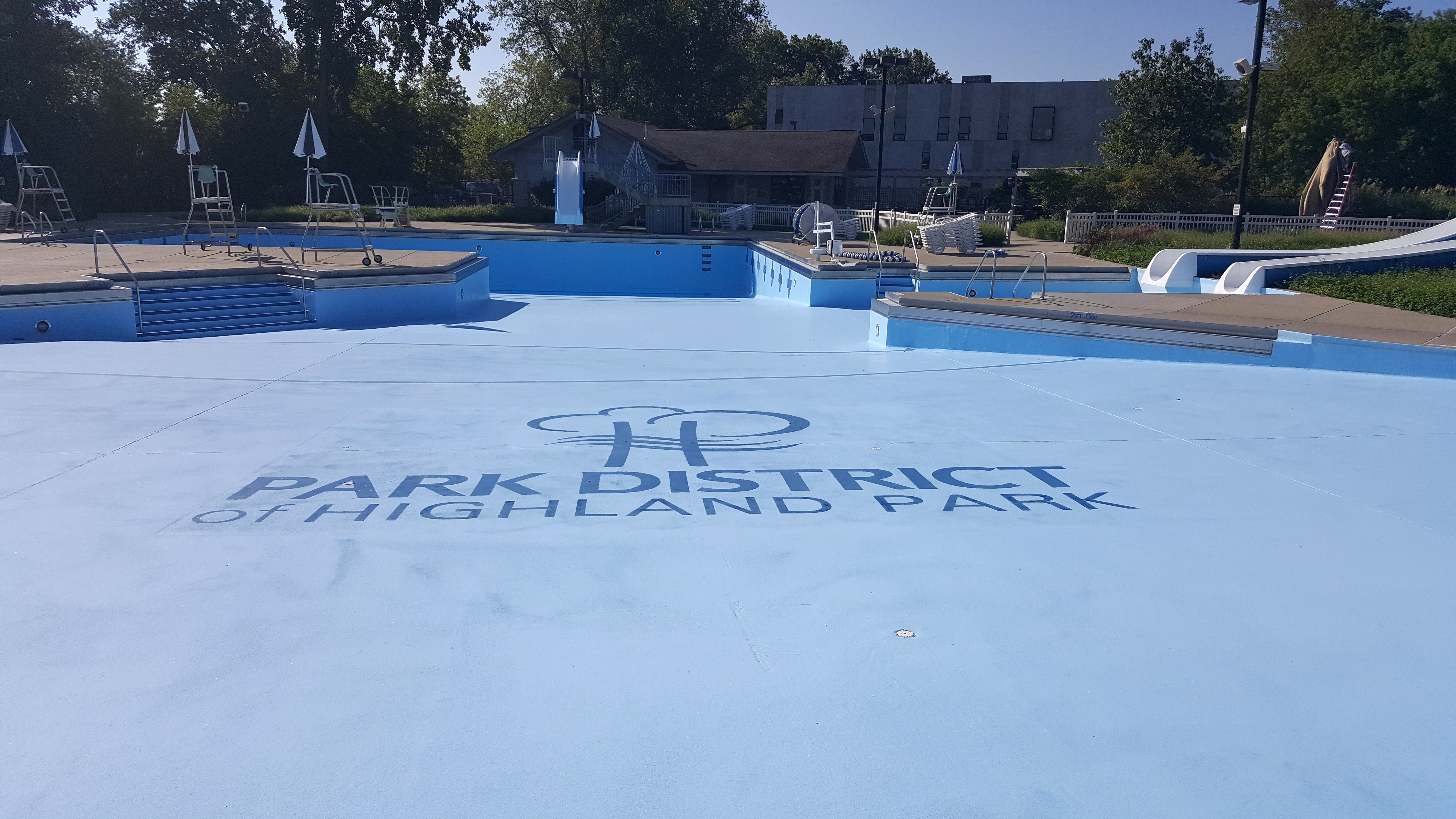 image of park district logo painted on swimming pool floor using paint mask stencils
