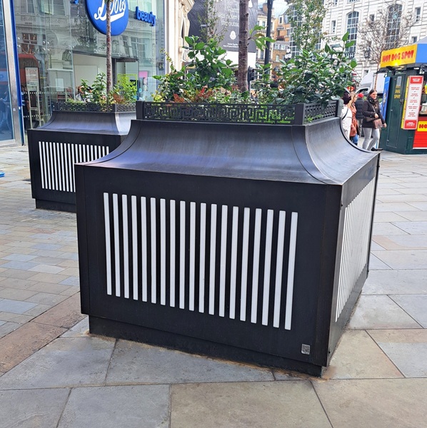 AM.P3 patinated brass planters at Piccadilly Circus.