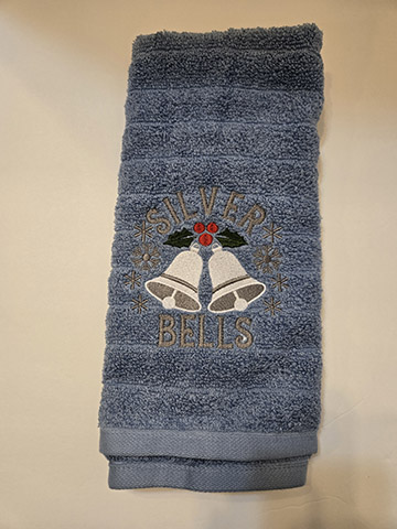 Blue hand towel featuring silver bell design