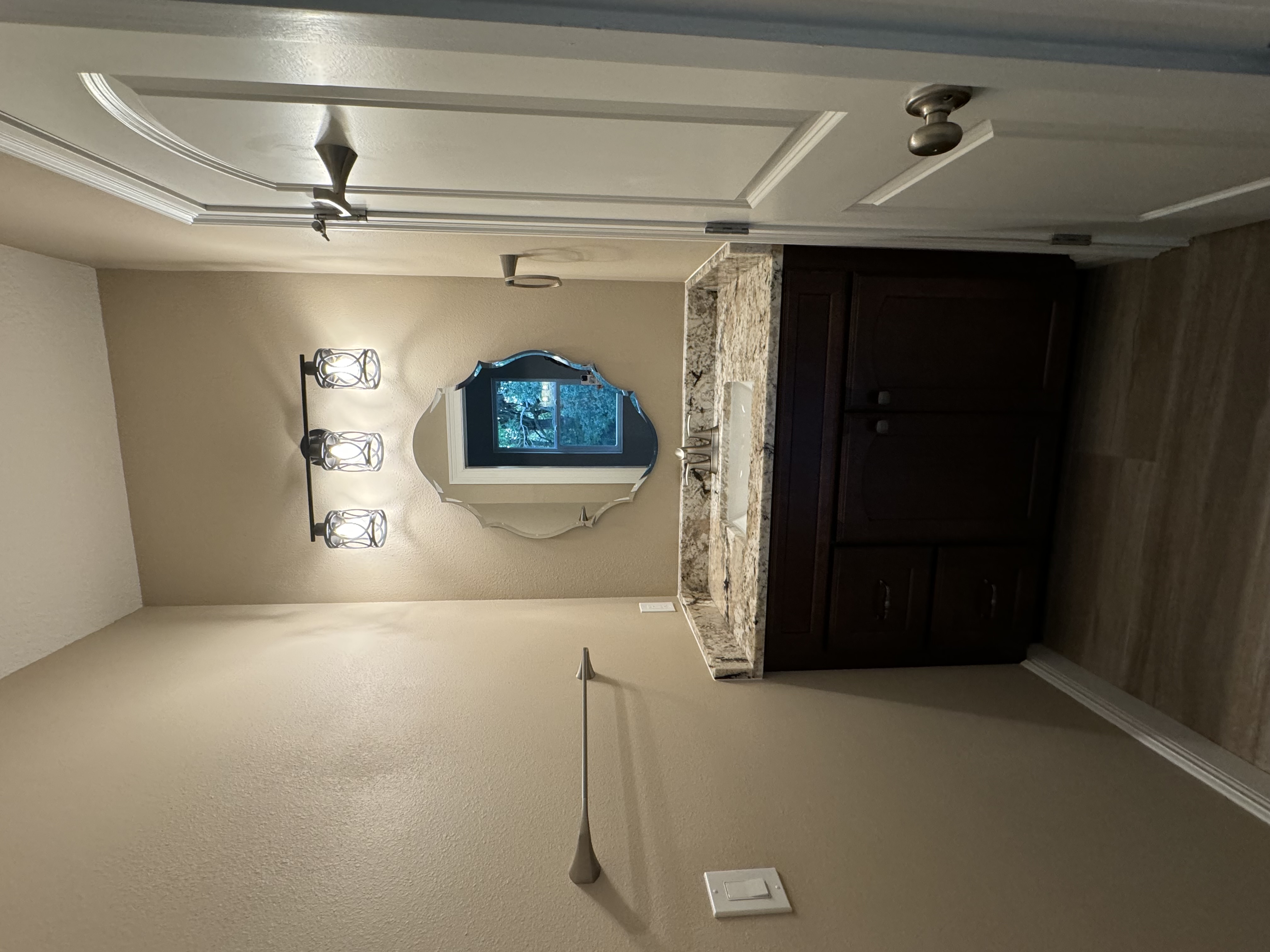 Lovely half-bath vanity featuring maple wood stained Giner Snap cabinetry, single sink, and granite countertop with 4" matching backsplash.