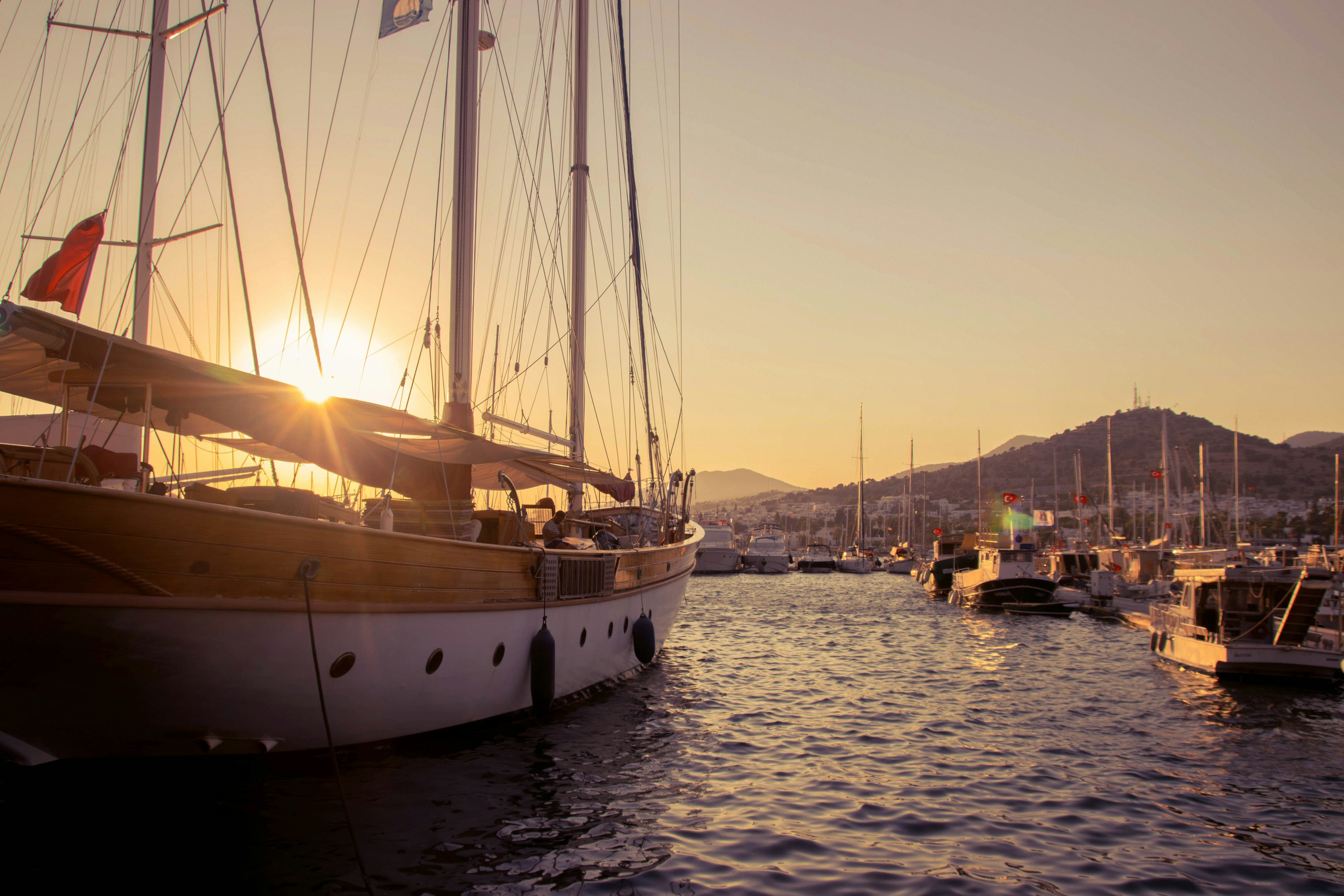 A group of boats floating on top of a body of water