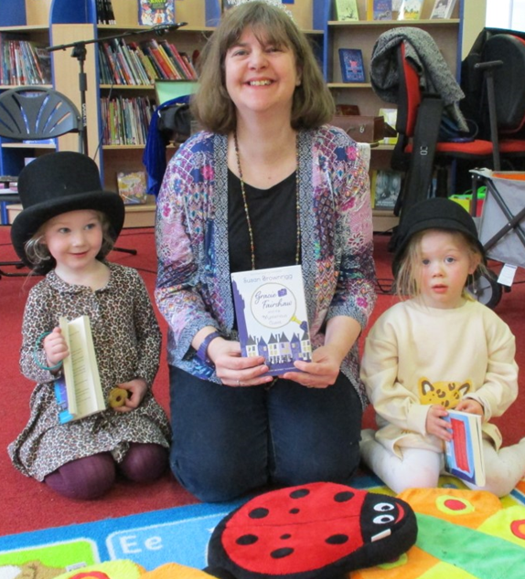 Susan Brownrigg at What's Your Story, Chorley with two children in dress up hats