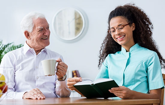 Nurse Helping To Read A Book