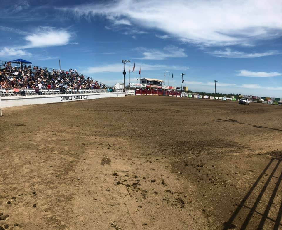 a group of people walking around a dirt field