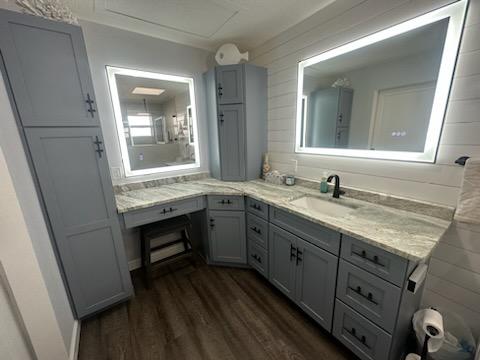 This stand-out bathroom features ship lap, lighted mirrors, extra storage, and a sitting/makeup area.