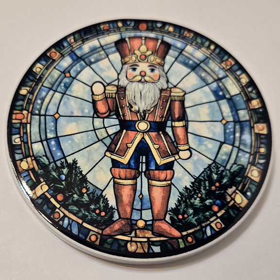 Round ceramic coaster with a stained glass nutcracker design