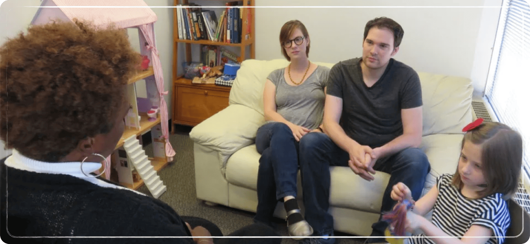 Family in a counseling session with a young child.