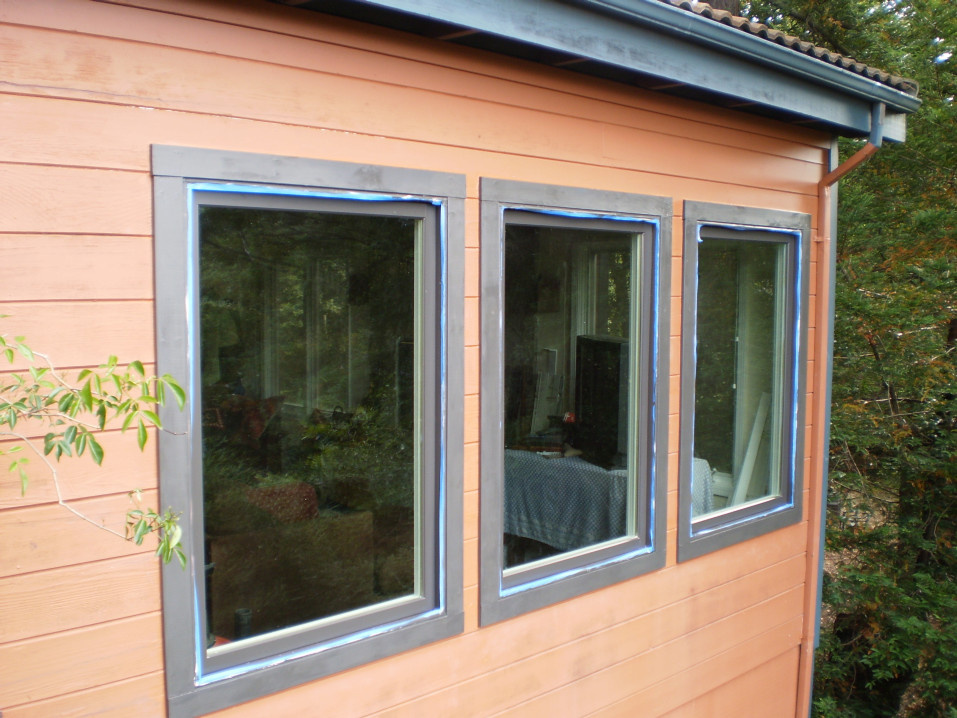 Replacement windows. More view. Better insulation. (mid painting - blue tape present).