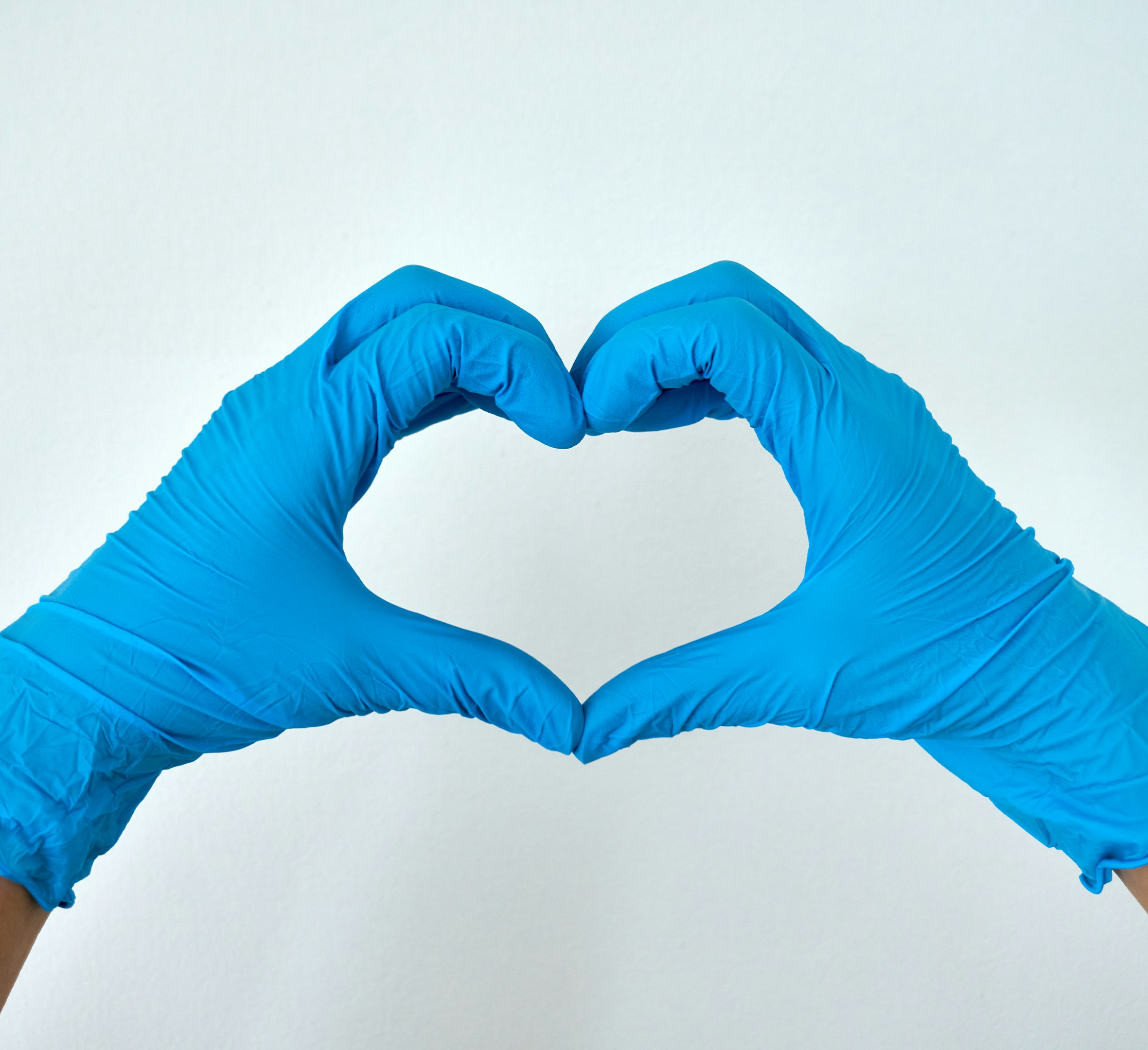 person in blue pants lying on white surface