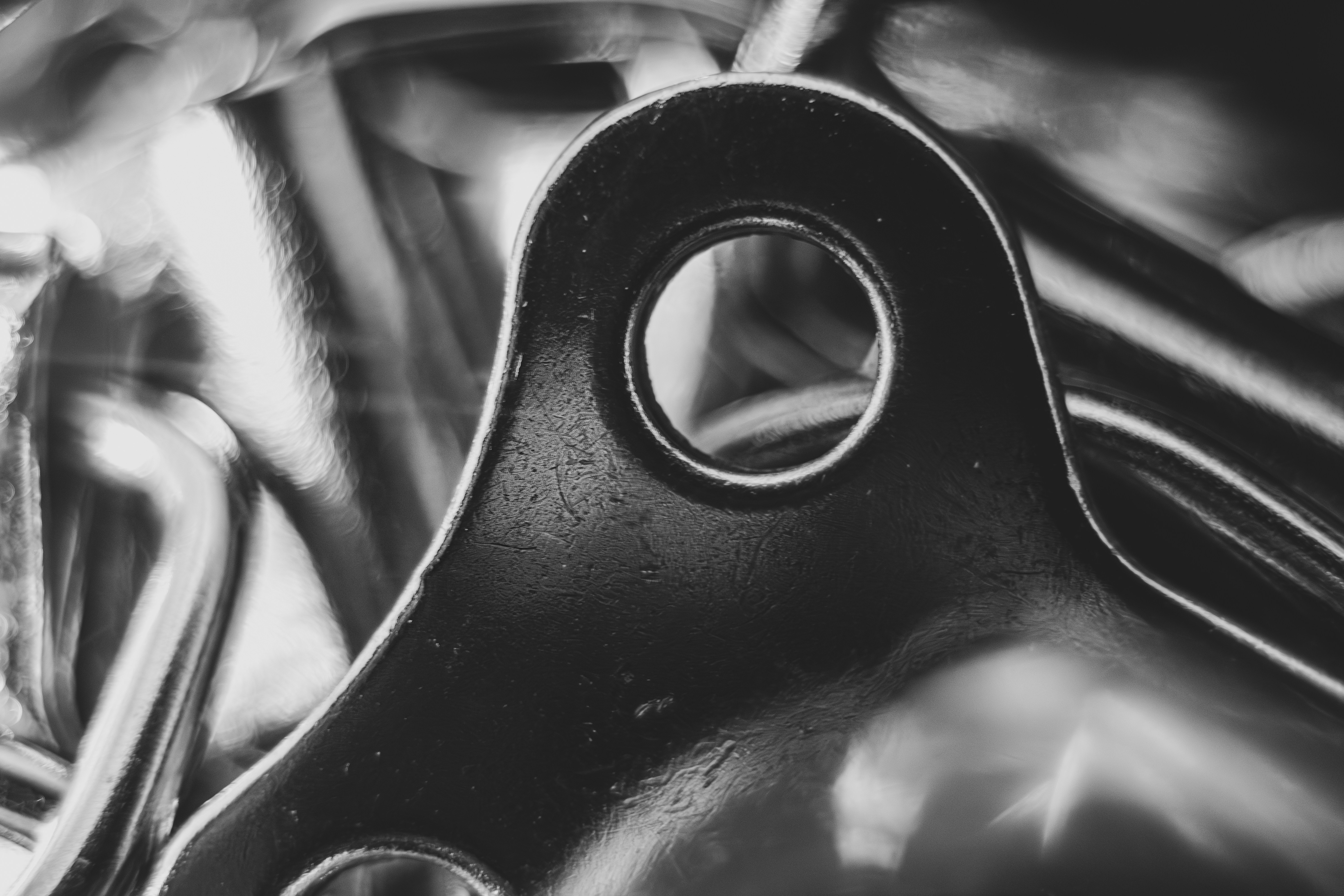 Close-up of a shiny metal bracket with a hole