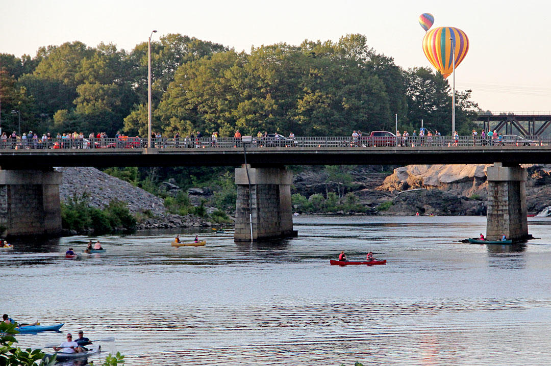 Boating on the river between 
Lewiston and Auburn at sunset 
during the Great Falls Balloon 
Festival in Maine 